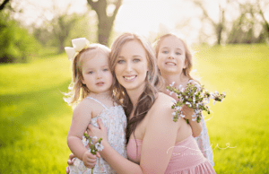 MOM AND TWO DAUGHTERS WITH FLOWERS