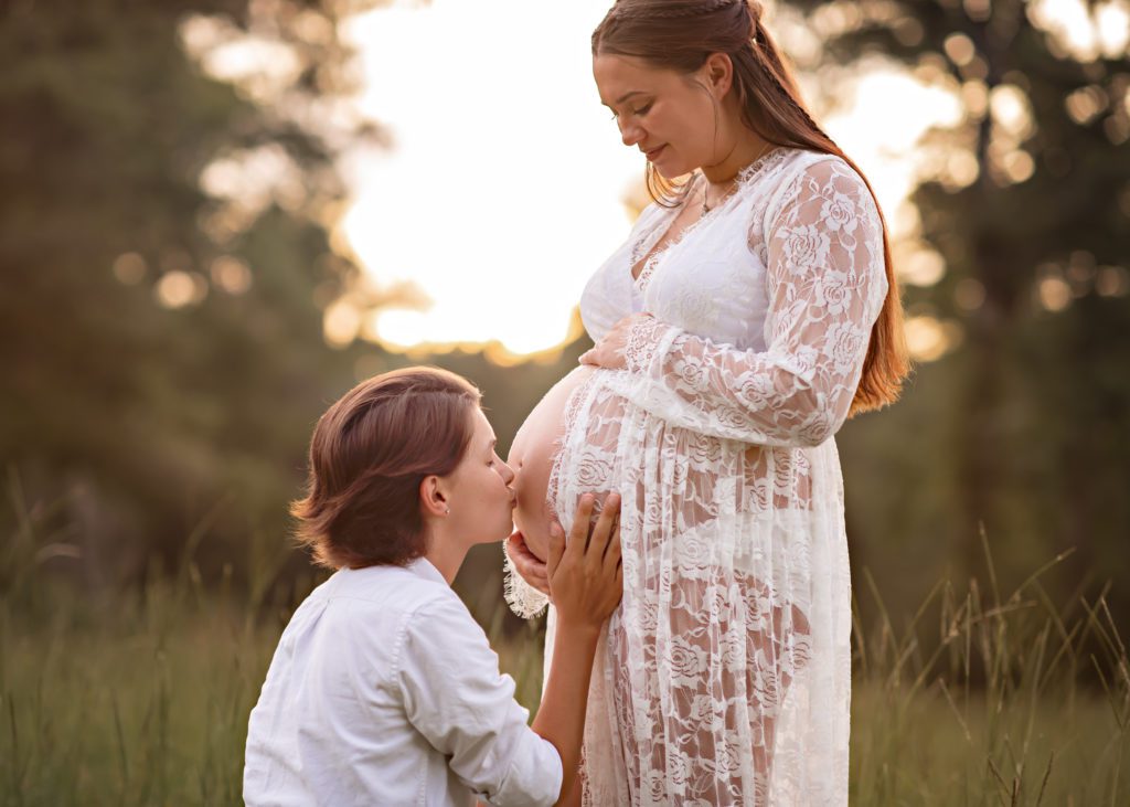 LESBIAN MATERNITY SESSION COUPLE KISSING PREGNANT BELLY